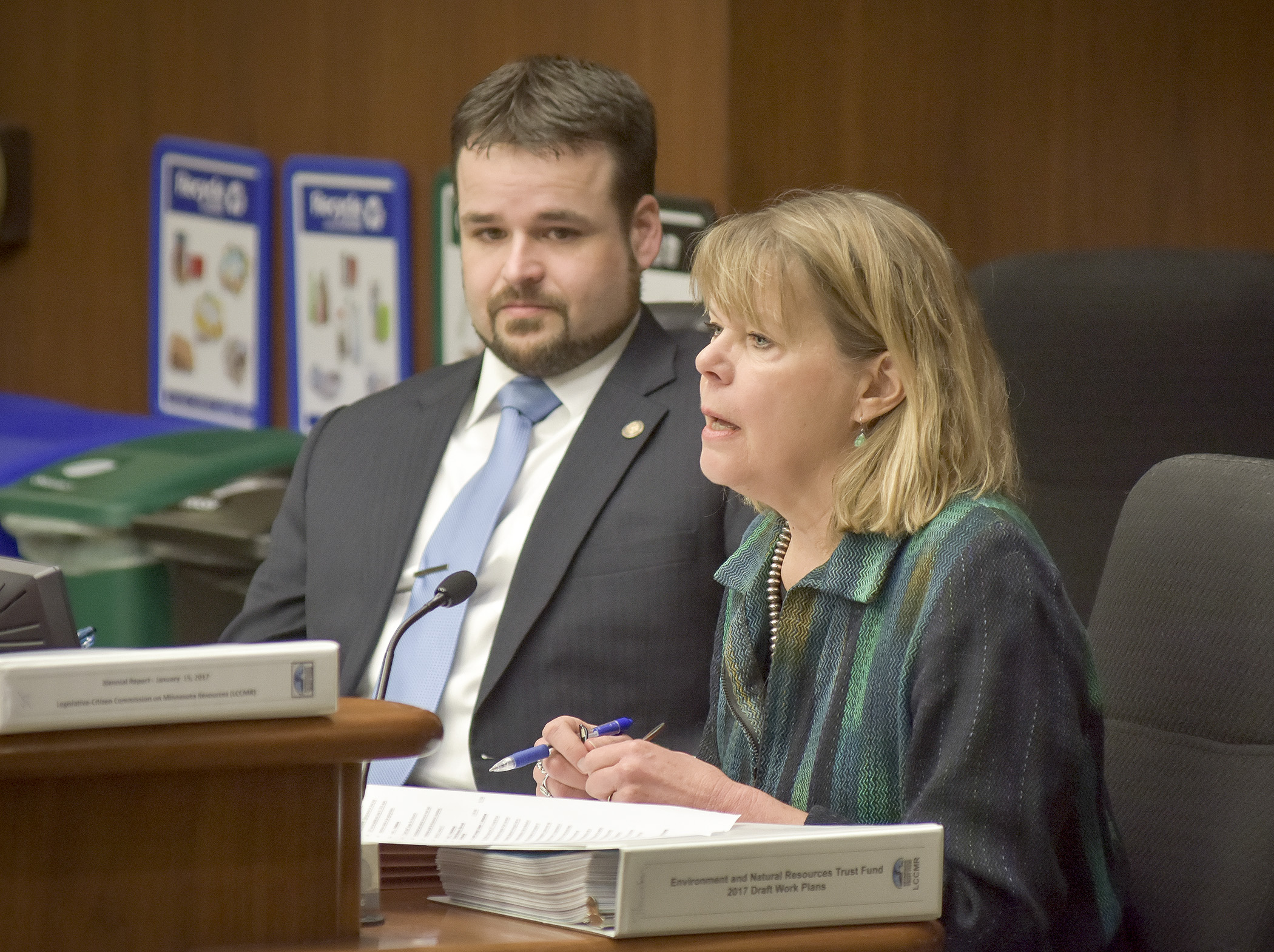 Susan Thornton, director of the Legislative-Citizen Commission on Minnesota Resources, testifies March 16 before the House Environment and Natural Resources Policy and Finance Committee on a bill sponsored by Rep. Josh Heintzeman, left, that would appropriate environment and natural resources trust fund money. Photo by Andrew VonBank